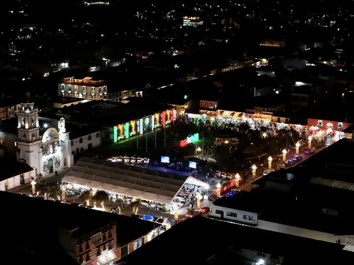 The main square of Chignahuapan at night during the street fair, aerial view