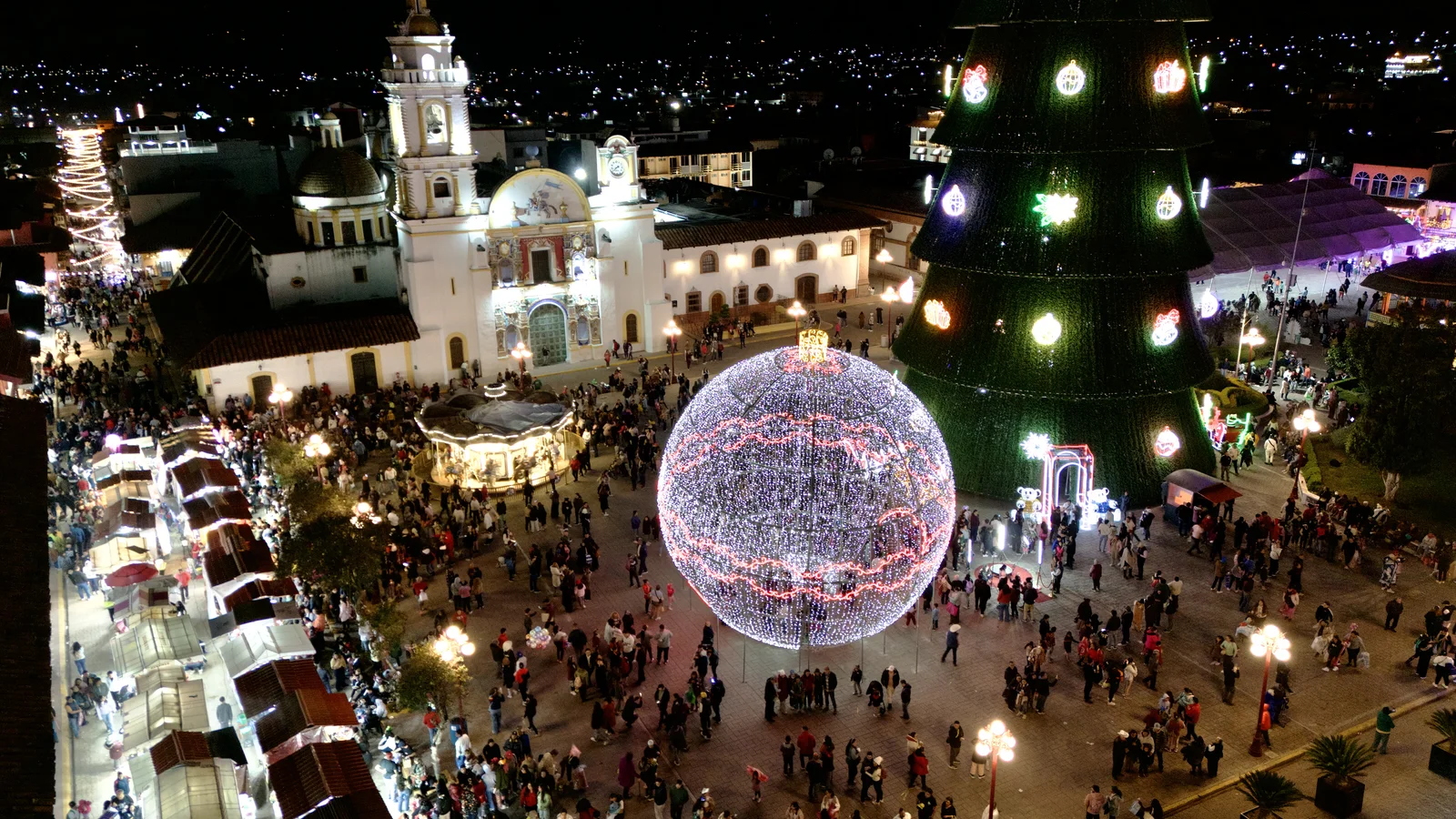 The giant tree and ornament lit up, seen from the air