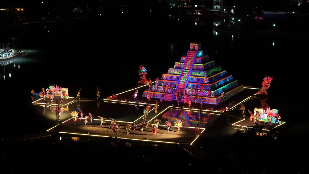 The illuminated pyramid on the lagoon, with dancers on the walkways, during the Festival of Light and Life